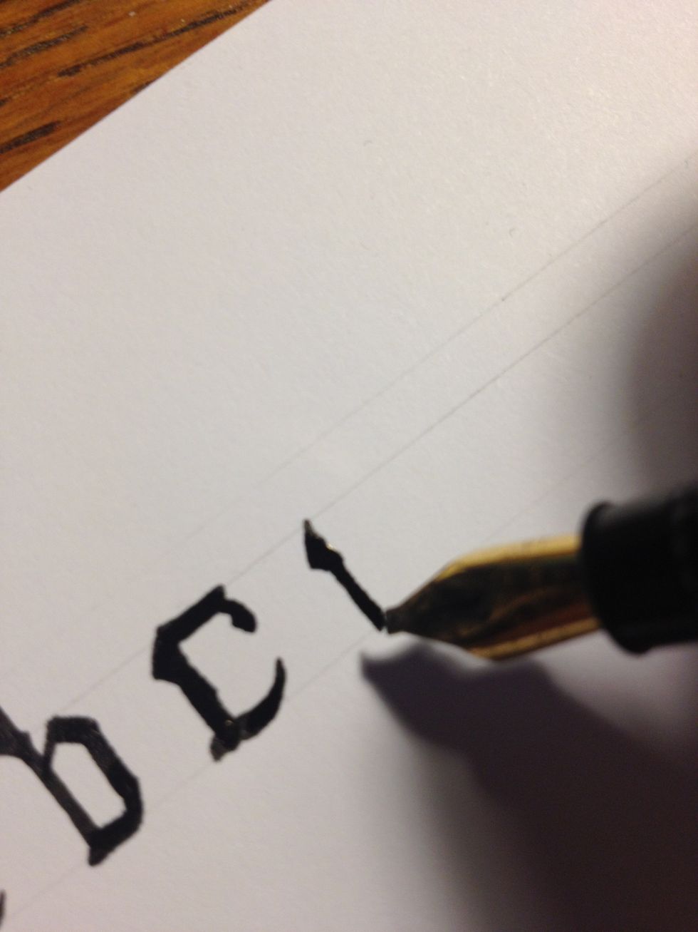 Letter "d" begins as a small trunk with an embellishment at the top. Take care: this is not the tall part of the letter, so don't make it any taller than your other Minuscules!