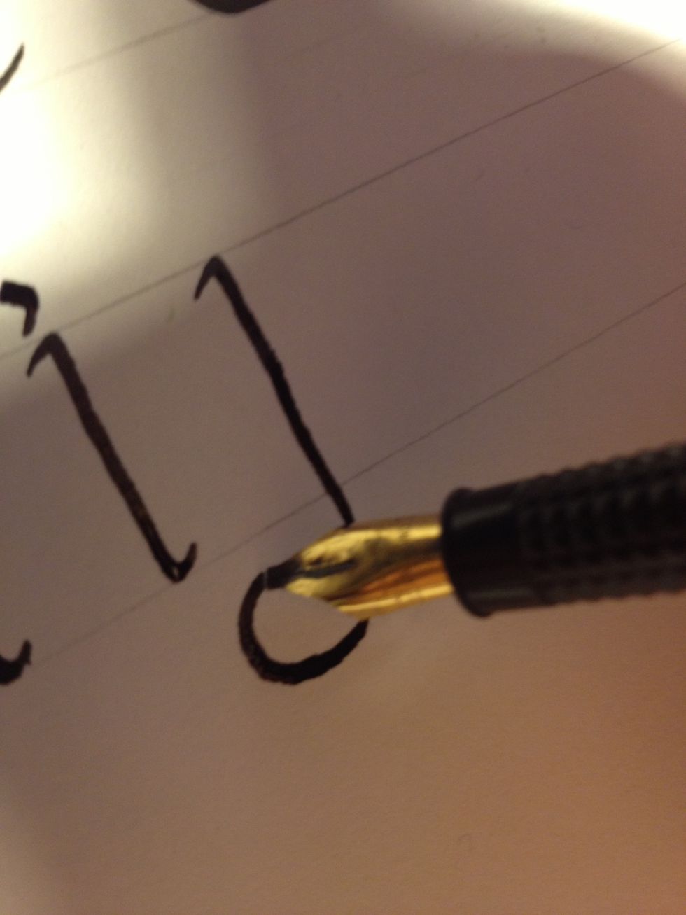 Letter "j" also begins with a basic trunk, but once you reach the bottom line keep going, creating a cane beneath it. Keep going until the line thins out, as shown.