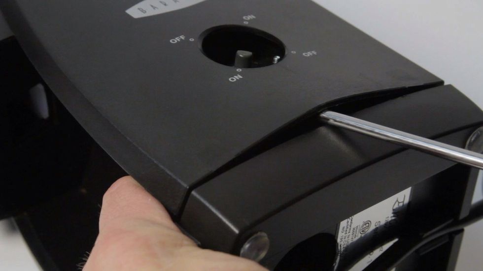 Lever down and push screwdriver in and up about half an inch. Wiggle side to side and pull up on case to release clips holding case in place.