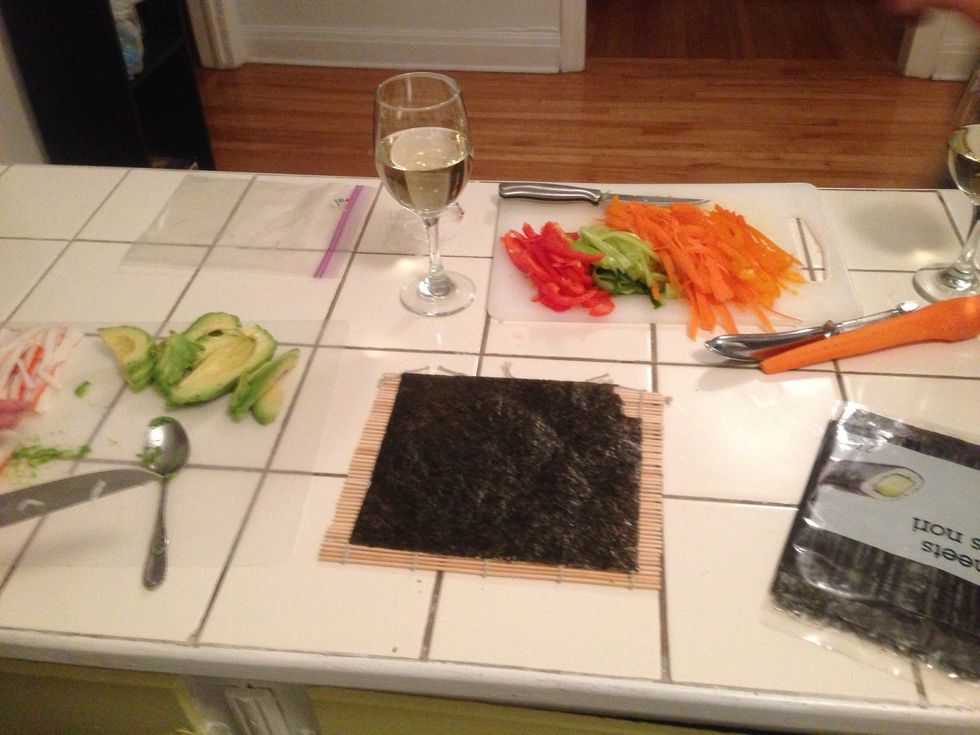 Lie the seaweed paper on top of the bamboo roller. While the rice is cooking pour yourself a glass of wine. ;)
