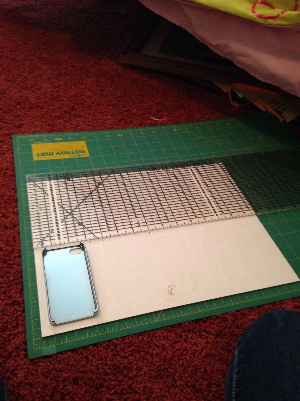 Lie your phone case down on the cardboard. With a ruler of sorts, mark how wide the "cover" of the case should be, as well as the spine. Extend the marks. Go to the next step for a reference photo)