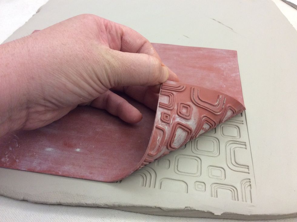 Lift a corner of the texture mat to check the clay before completely removing it.