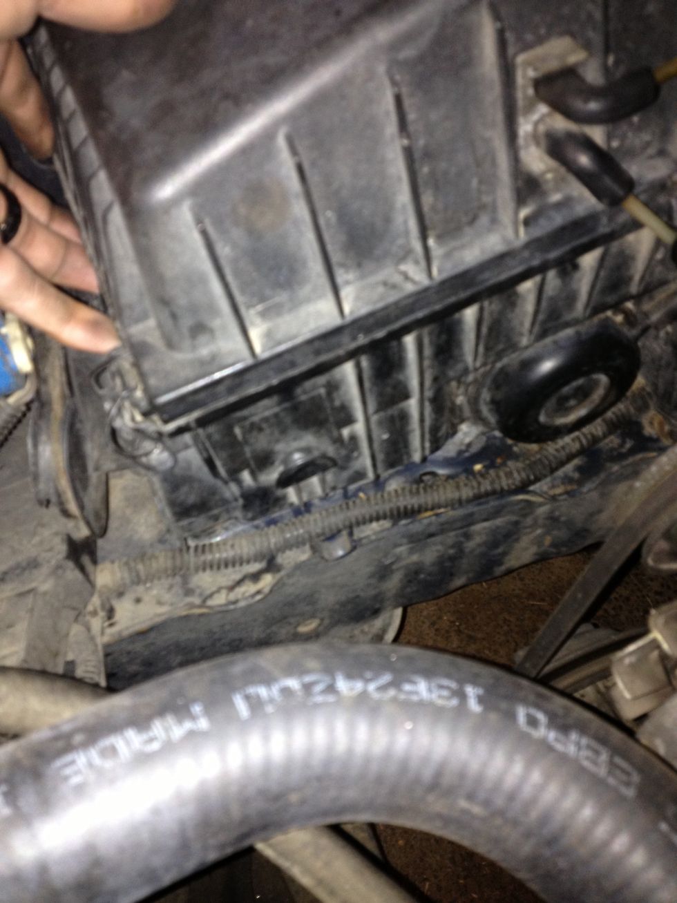 Lift air cleaner to expose lower exhaust hose