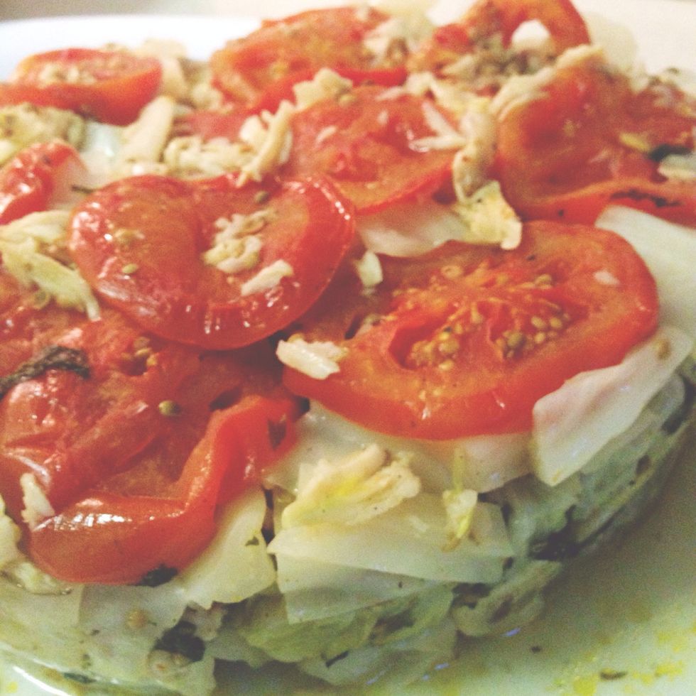 Lift pot up to reveal a hopefully intact "tower" of rolled cabbage leaves with the sliced tomatoes now on top!  Eat next to a tangy salad and some yogurt. Sahtein! (Eat with good health!)