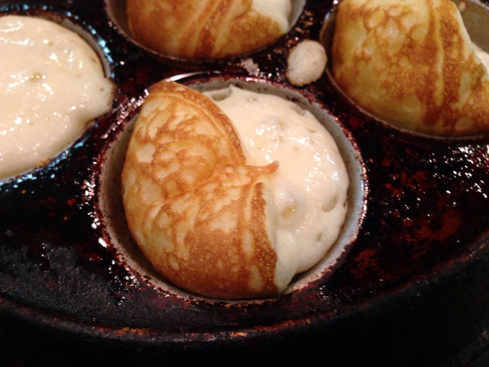 Lift the edge of each Aebleskiver 1/4 turn.