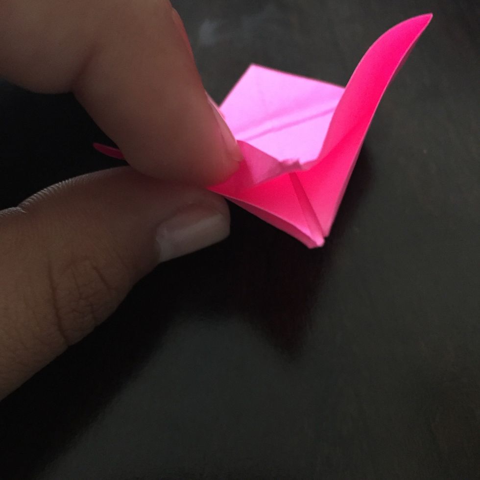 Lift the first layer of paper at the bottom.