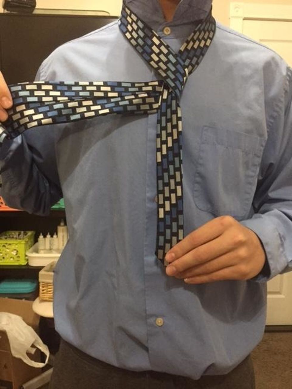 Lift the small end and bring the wide end under.