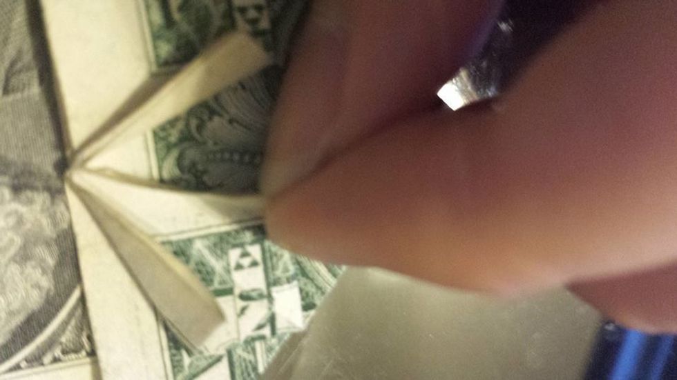 Lift the top layer of the square on the other side.