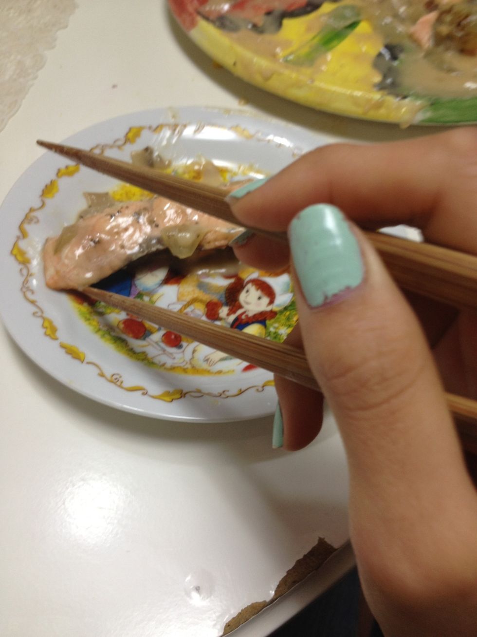 Lift the upper one to surround the food and the lower should be still so that one chopstick is on each side