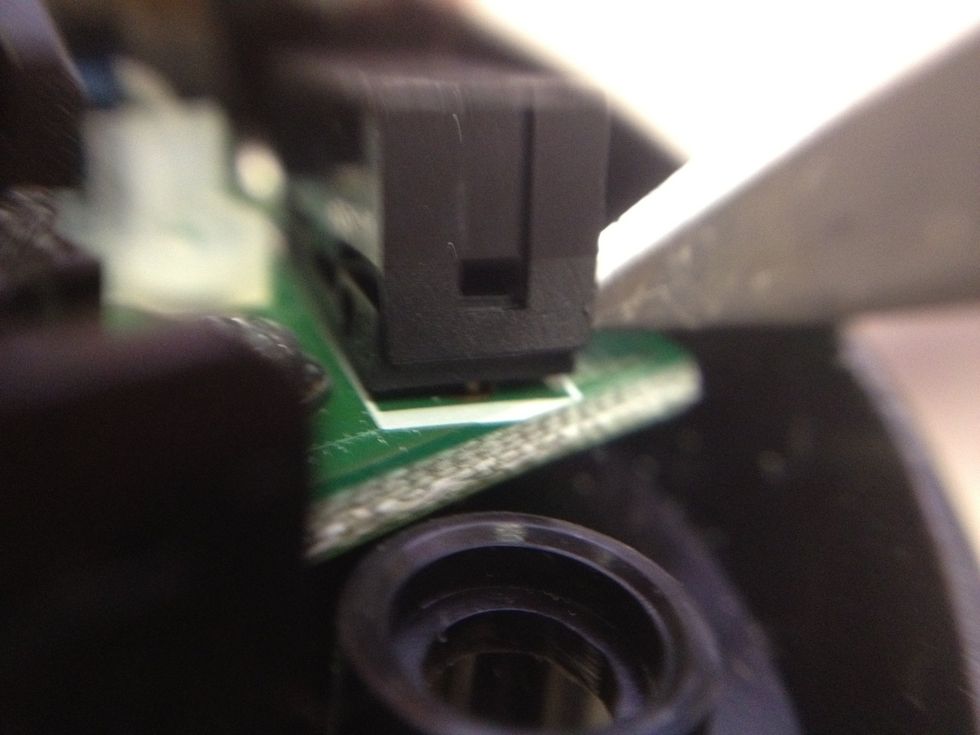 Lift up on the tabs to remove the cover drone the buttons