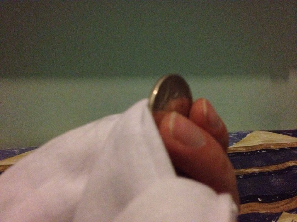 Lift up the front of the handkerchief and show the coin.