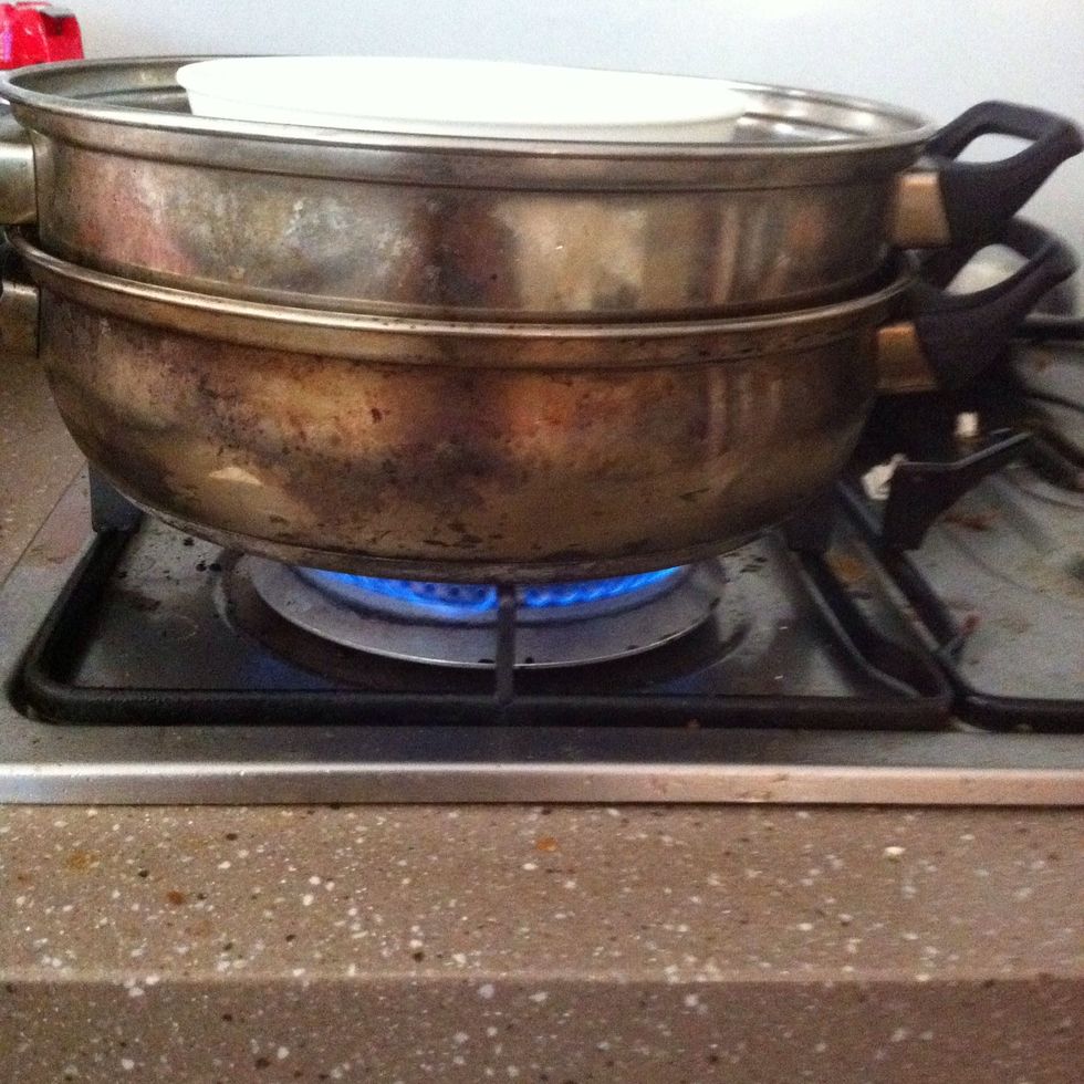 Light stove (turn on electricity for electrical steamers) and place bowl on a tier