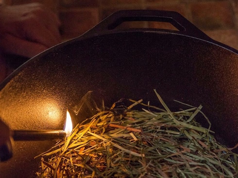 Light the edges of the hay so they smolder a bit. DO NOT set it on fire.