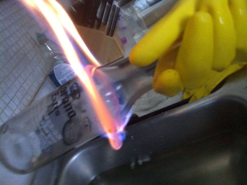 Light the yarn on fire, and rotate the bottle until the flame goes out. Pretty hot gloves, huh? \ud83d\ude09