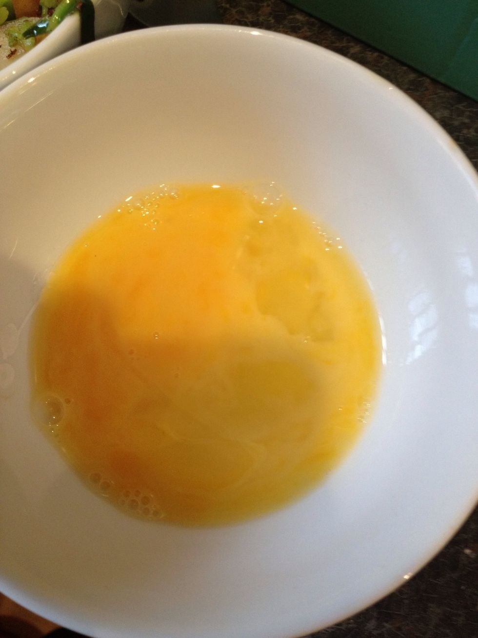 Lightly beat 1 egg in a bowl