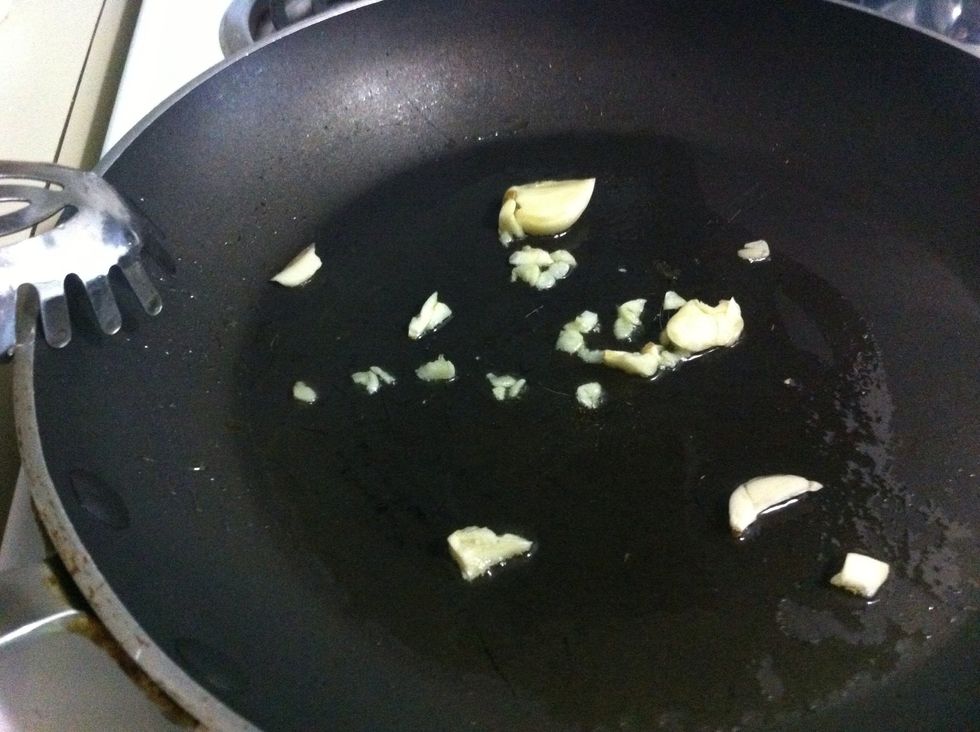 Lightly brown garlic in oil