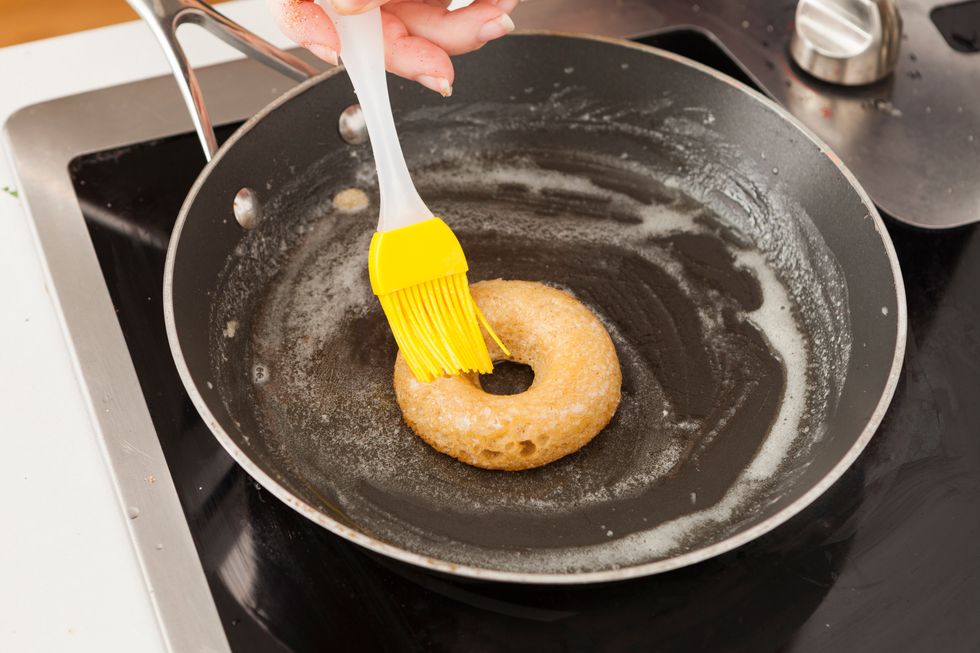 Lightly brush each donut with butter.