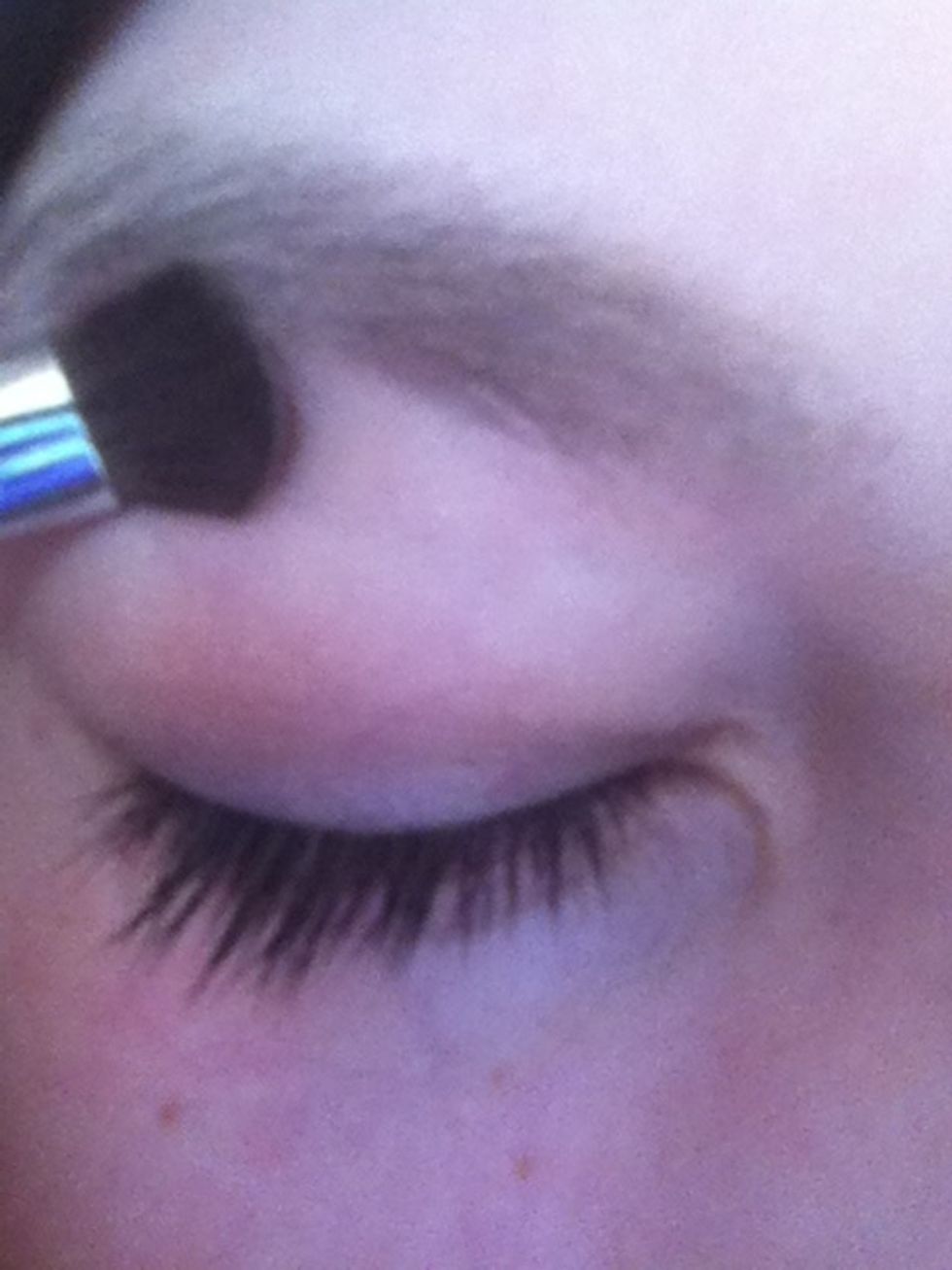 Lightly brush just under the arch of your eyebrow.