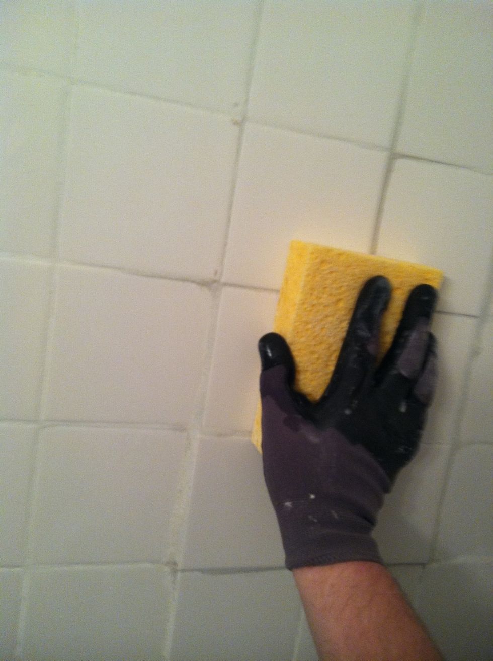 Lightly drag sponge across surface of the tiles, washing off excess grout often.