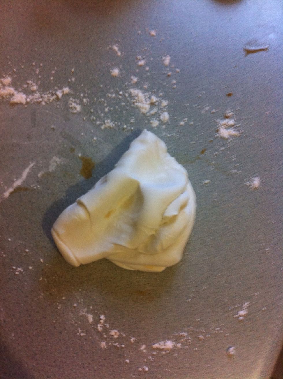 Lightly dust a flat surface with icing sugar and knead fondant until smooth, gradually adding the vanilla - add more icing sugar if needed.