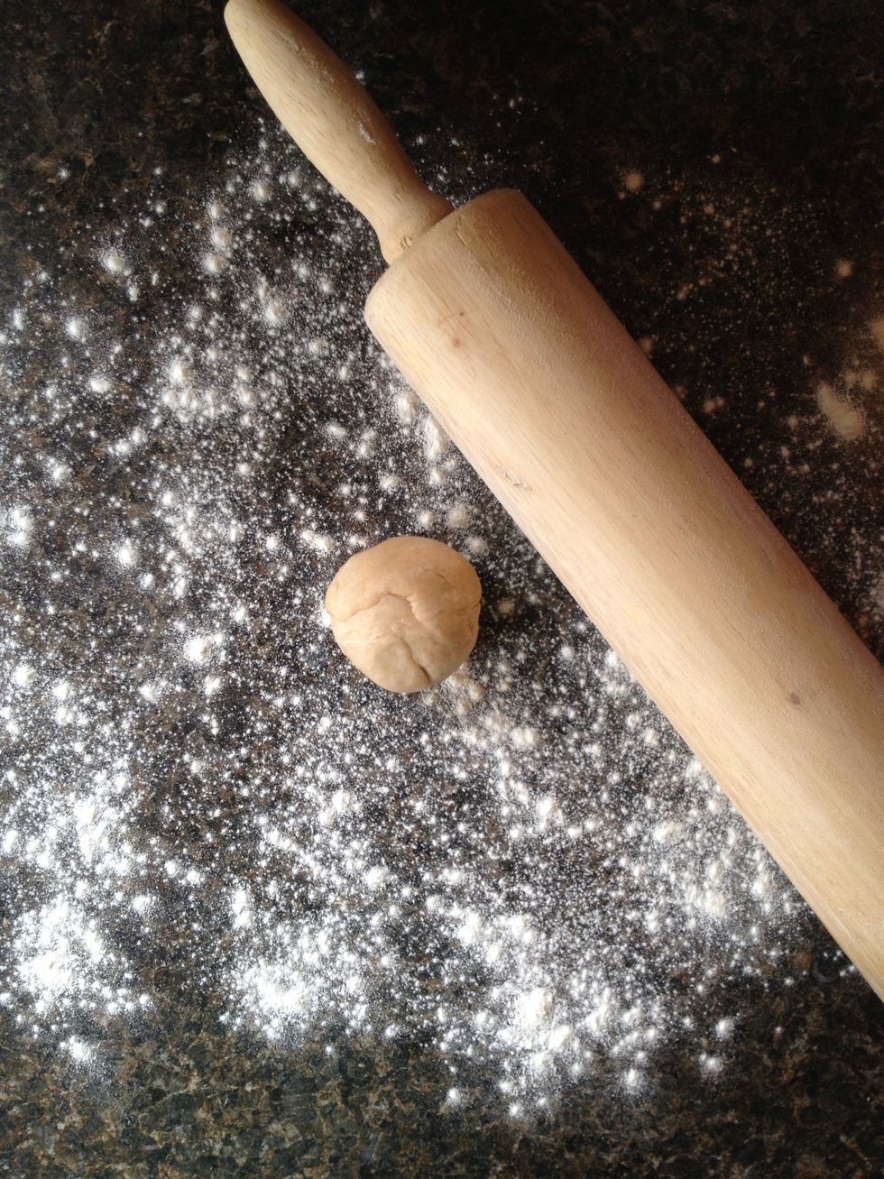 Lightly flour your smooth clean work surface. With your hands, work the first piece of dough into a ball. With a rolling pin, roll out the dough as thin as possible.