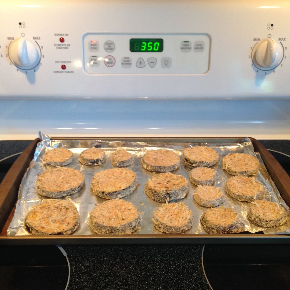 Lightly grease a baking sheet with olive oil. Place breaded eggplant slices on sheet and bake in preheated oven at 350 degrees Fahrenheit for 5 minutes.
