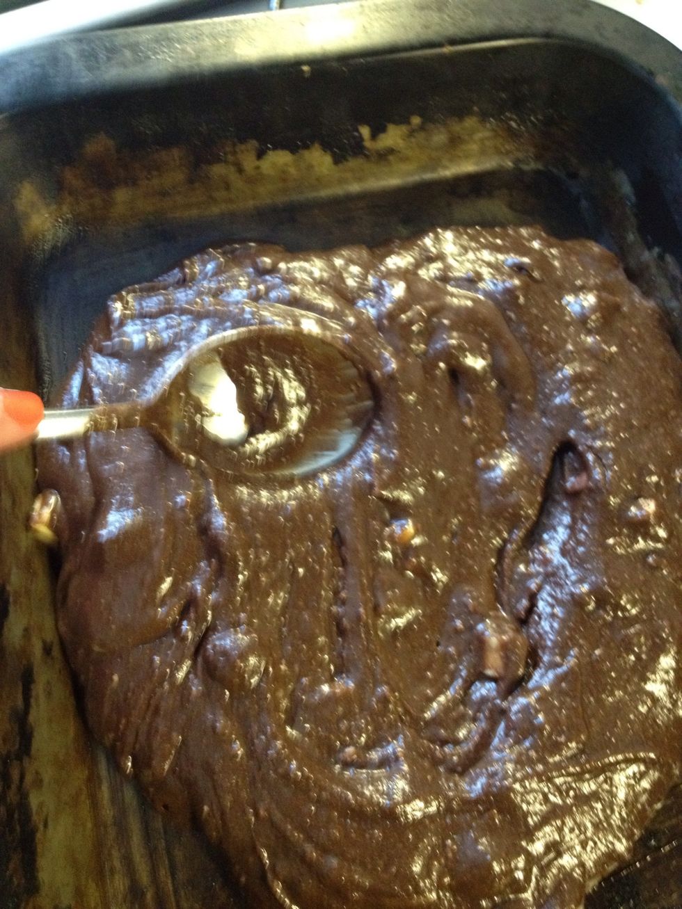 Lightly grease a square or oblong shallow baking tin with butter, a loaf tin would work for thicker brownies. Then spread the mixture into the tin. Doesn't need to be neat, it works itself flat.