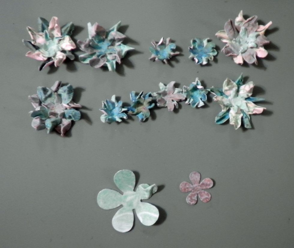 Lightly mist each flower with water and pinch for a shabby look. Layer two large and one small petals together for the large flower, and two small petals together for the small flower.