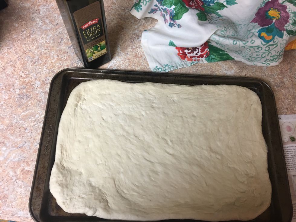 Lightly oil sheet pan. Gently stretch and roll the dough to a 1/4 inch thickness. Carefully transfer to prepared pan.