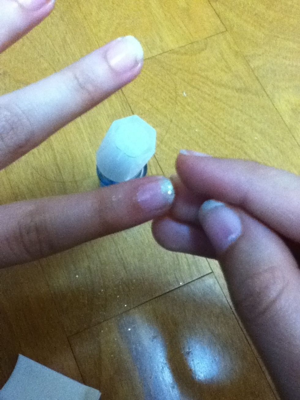 Lightly pat your nails so that the glitter will stick and be even