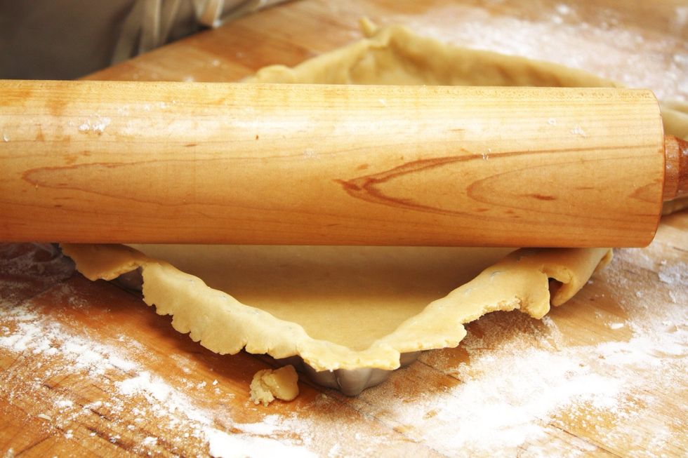 Lightly press down the corners and the bottom of the pan to lay in the dough and press excess toward the outside edge. Roll the pin over the dough to trim off extra. Gather trimmings for other use.