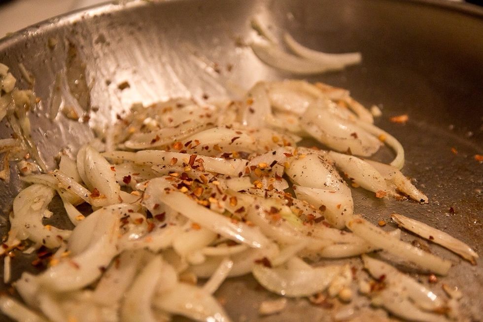 Lightly saut\u00e9 onions, garlic and chili flakes.