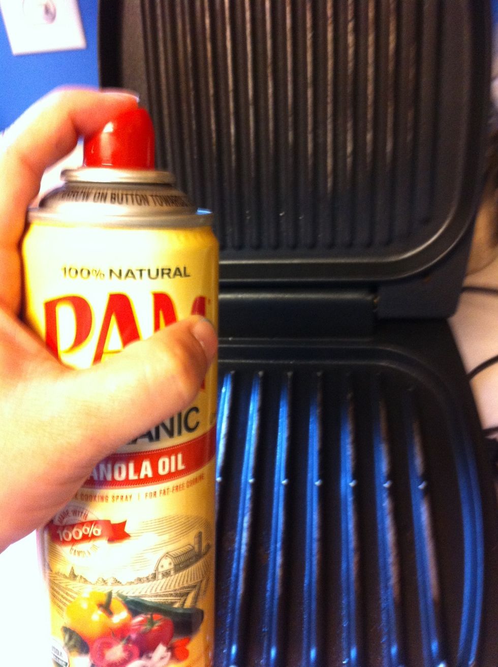 Lightly spray non-stick cooking spray onto grill and plug grill in.