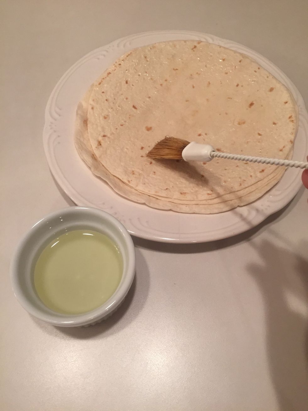 Lightly spread vegetable oil on one side of a flour tortilla.