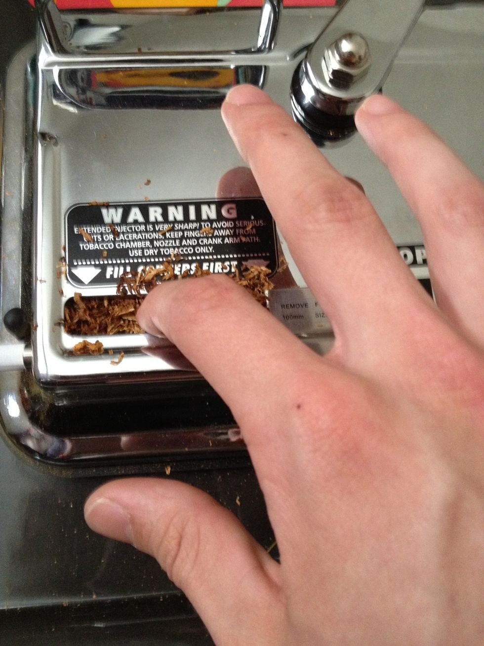 Lightly tap the tobacco in but remember to pack down the two corners of the chamber first to make a solid smoke.