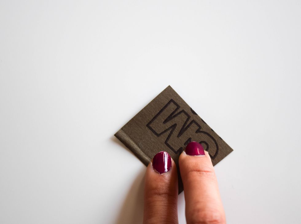 Lightly use abrasive paper to evenly roughen up the surface of the shrink plastic. This will allow the colored pencil pigment to stick to the plastic.