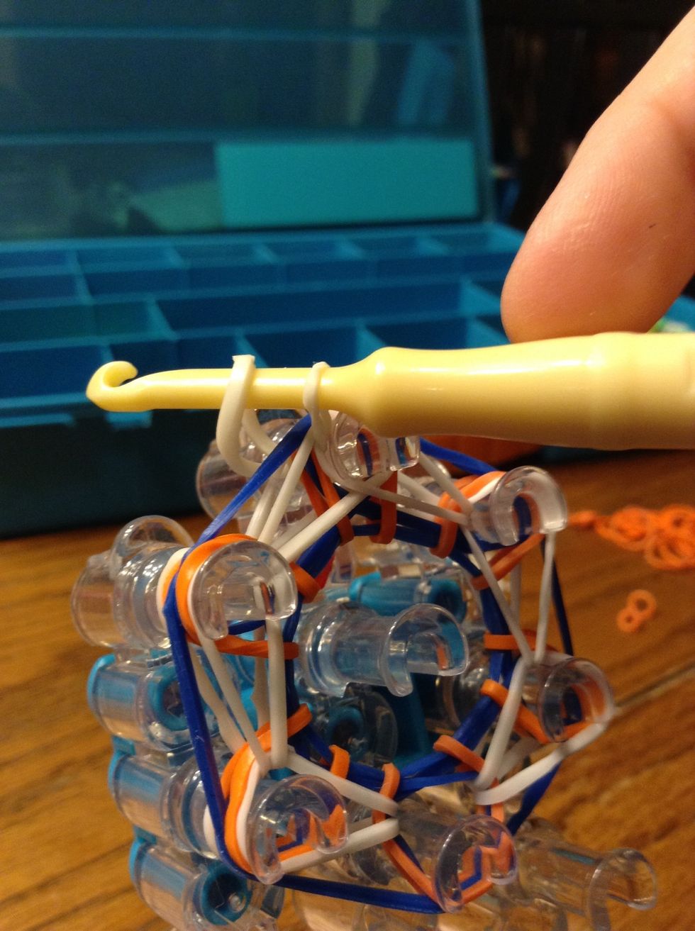 Like so. Now pull the charm off the loom.