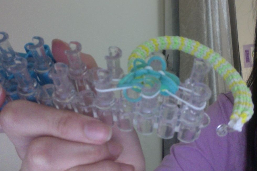 Like so. These are 3 white bands put back onto 3 of the 6 pegs.