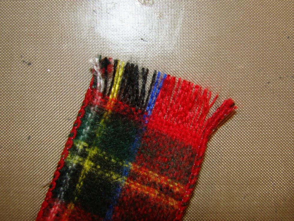 Like this... just start pulling threads horizontally out from the ends of the ribbon till you get the fringe length you desire.