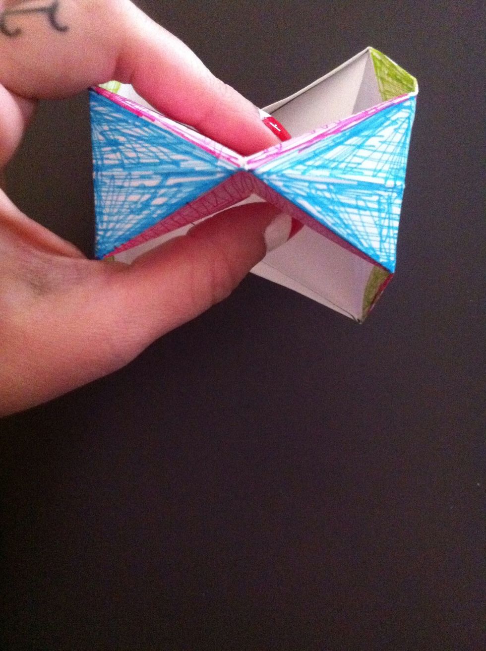 Like this. The blue area made a bow tie. Pinch in the other two pink areas the same way...