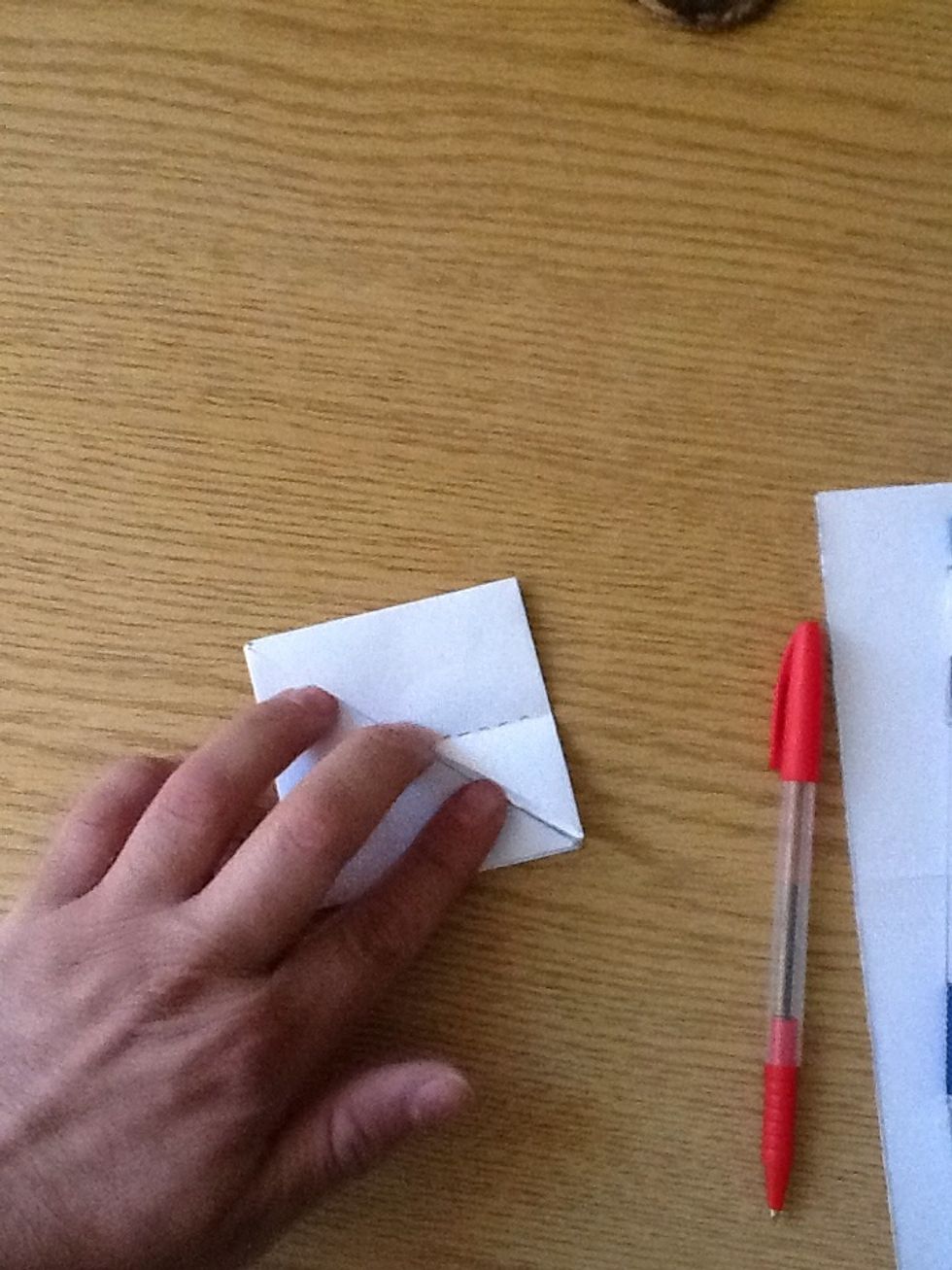 Like this! The two squares are now two triangles.. It will look like two layers of triangle on top of each other.. (The doted line is drawn for the next step..)