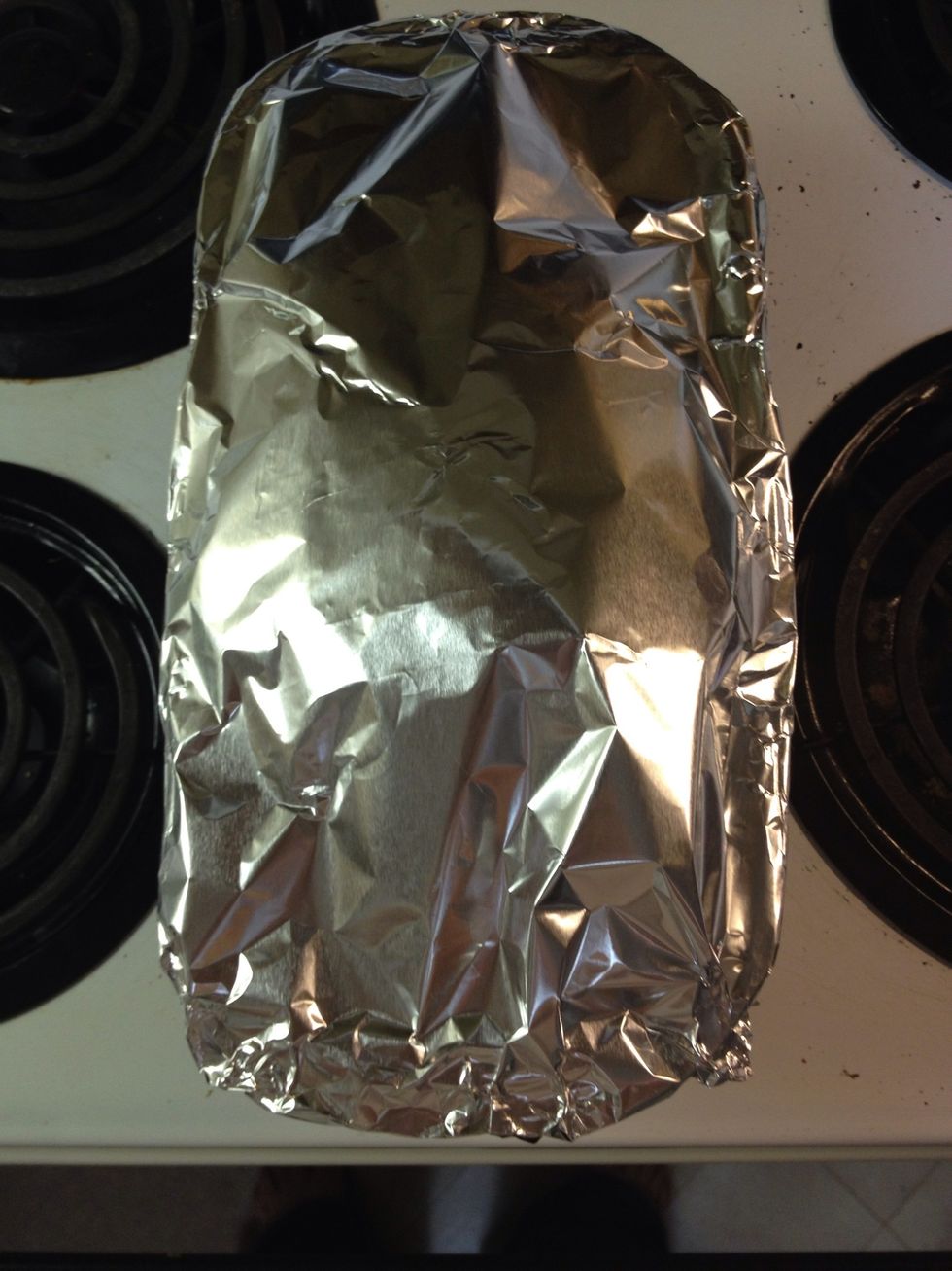 Like this! This will prevent it from burning or getting darker. Place the loaf back in the oven!
