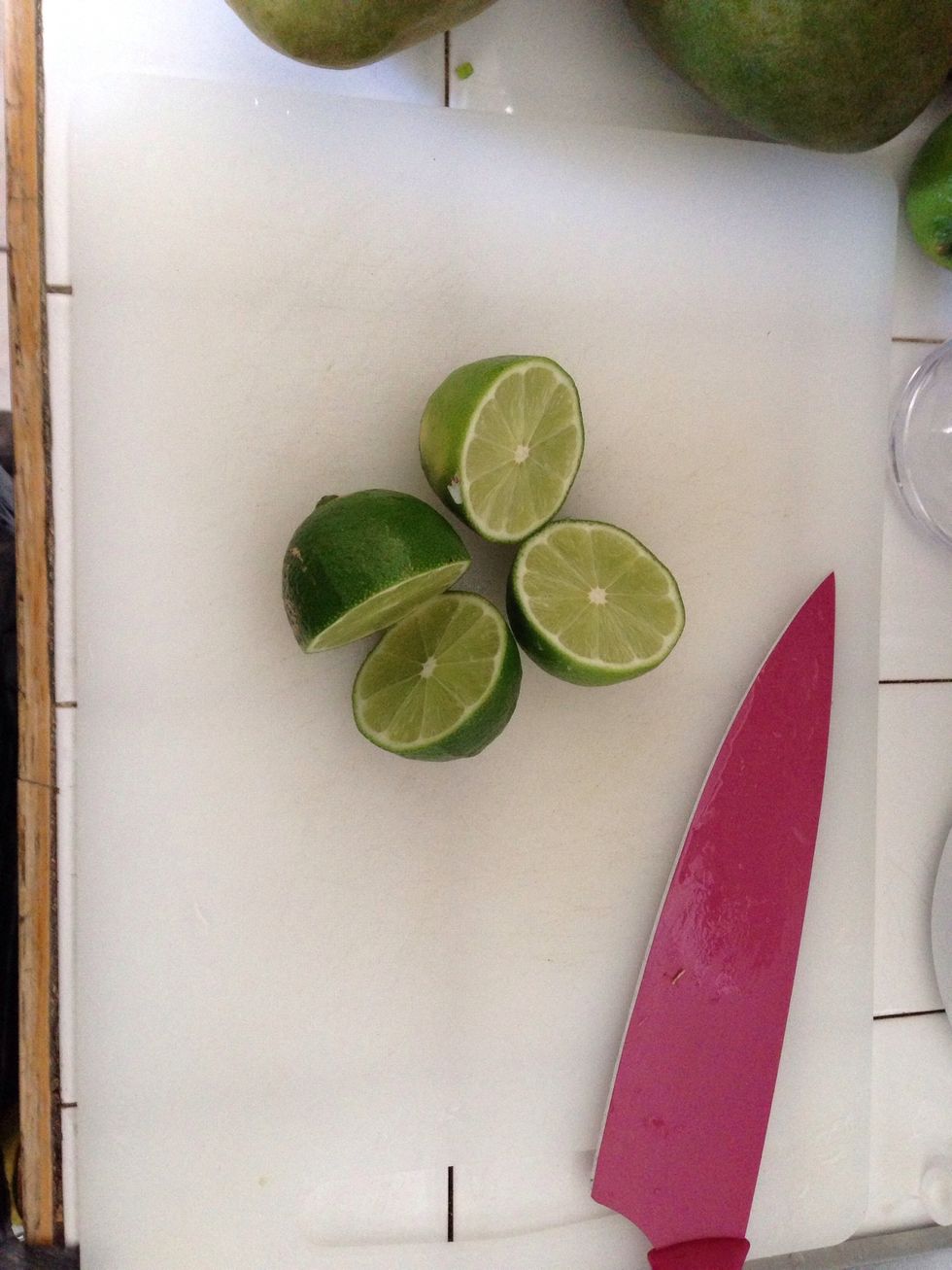 Lime sliced and squeezed into a deep bowl.