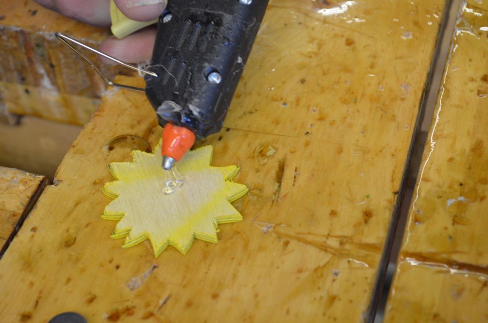 Limma fast magneten pa\u030a baksidan med hja\u0308lp av en sma\u0308ltlimspistol.