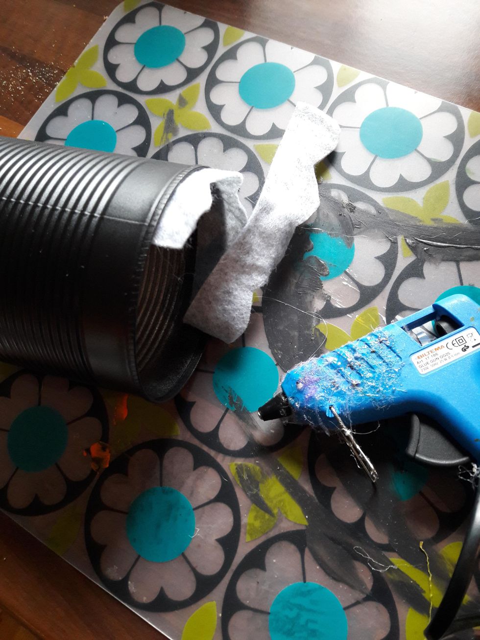 Limma fast remsan p\u00e5 insidan av burken med limpistol.