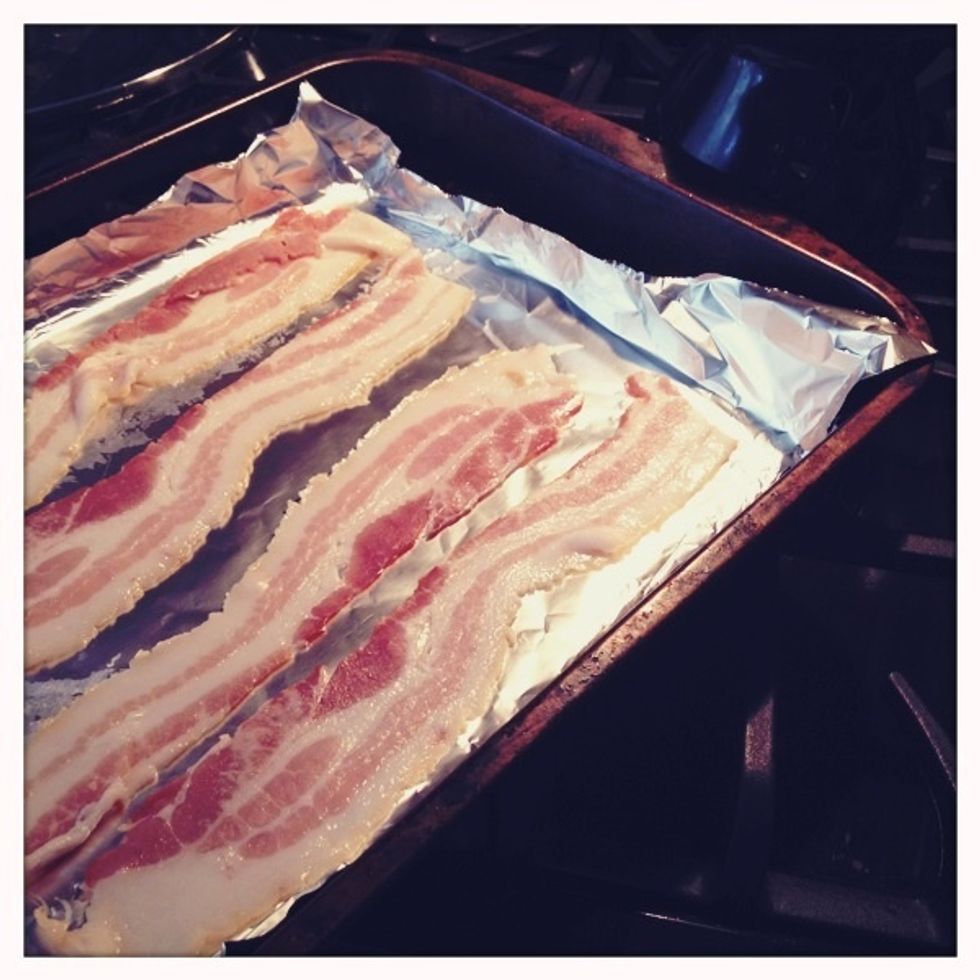 Line a baking pan with aluminum foil, turn up the edges, and add bacon.