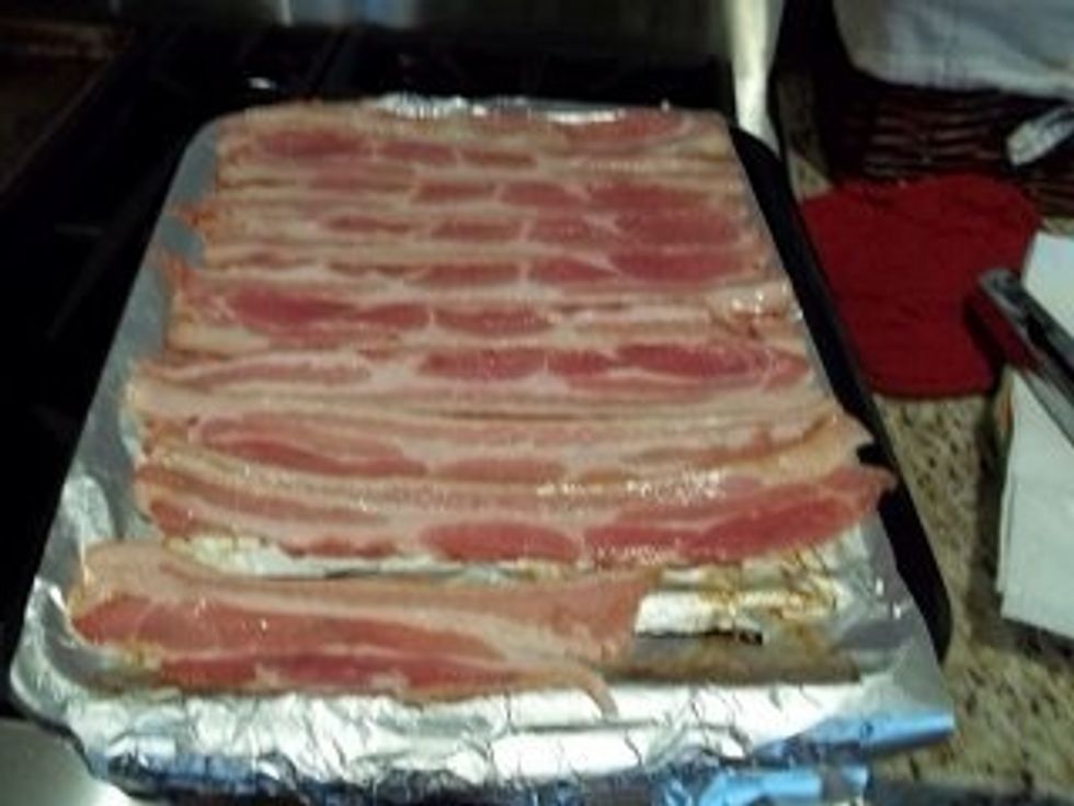 Line a baking sheet with tinfoil and just place the bacon down. It should take about 10 minutes to cook.