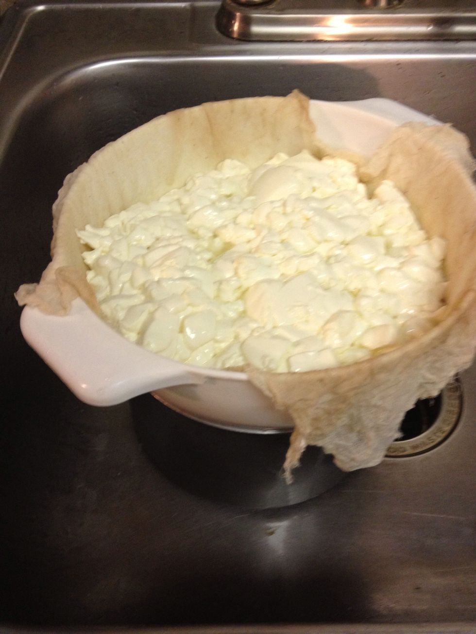 Line a colander with cheesecloth placed over a pot and carefully pour the curds and whey in.