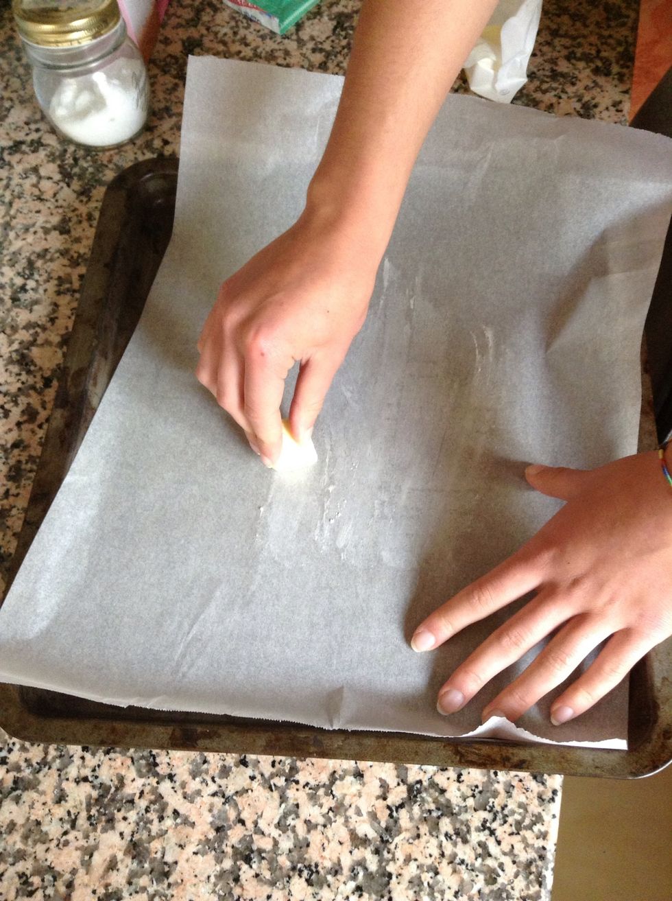 Line a large tin with parchment paper and butter. We need to make sure it doesn't stick while baking.
