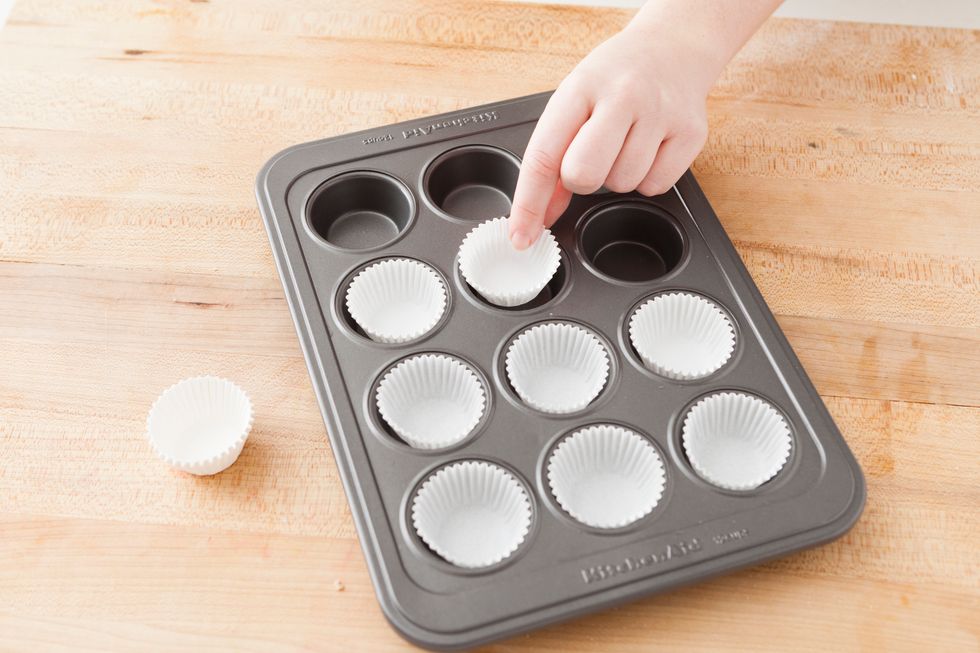 Line a mini muffin pan with mini paper muffin tins.